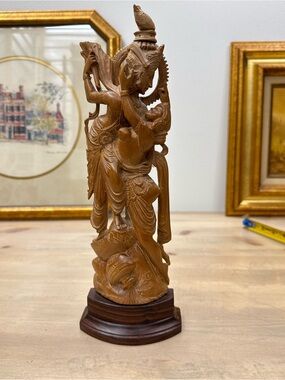 Hand-carved wooden statue depicting the Hindu deities Radha and Krishna